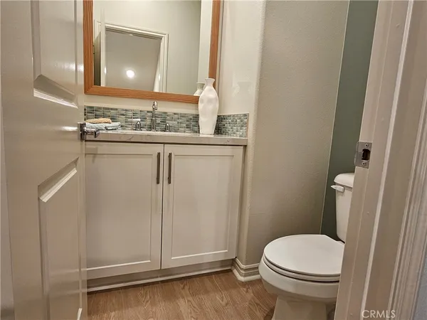 a kitchen with stainless steel appliances kitchen island granite countertop a table chairs sink and cabinets