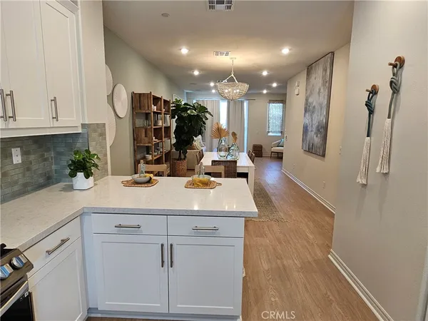 a dining room with furniture and wooden floor