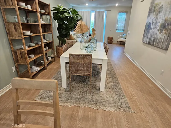 a view of a balcony with two chairs and a potted plant