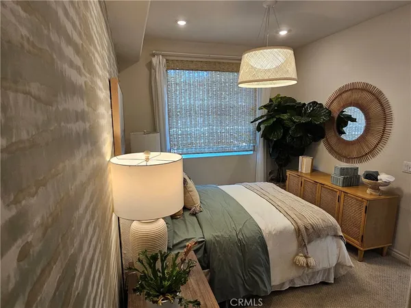 a bed sitting in a bedroom next to a brick wall