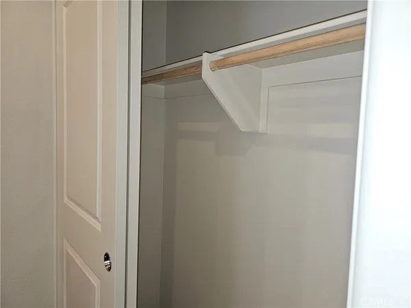 a bedroom with a bed and a flat tv screen tv