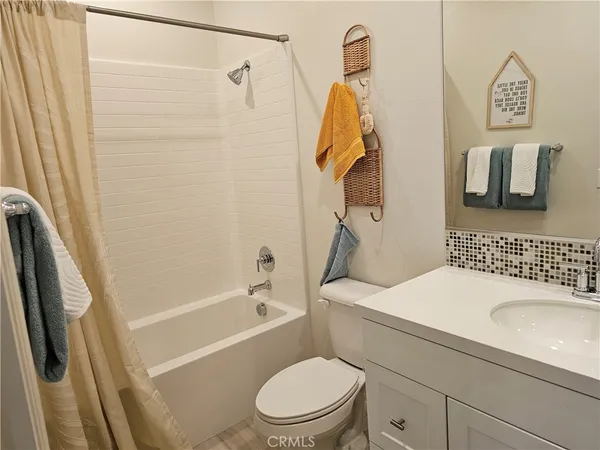 a bed room with a bed mirror and a chandelier