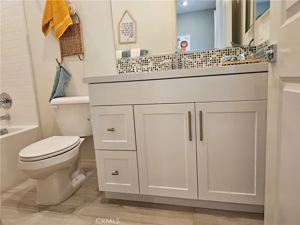 a spacious bathroom with a double vanity sink a mirror and a shower
