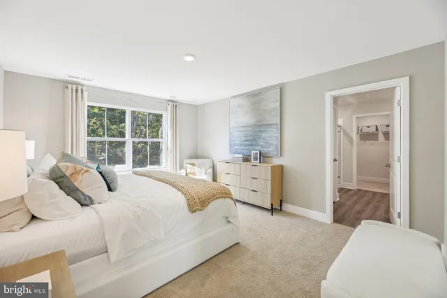 a bedroom with a bed and a large window