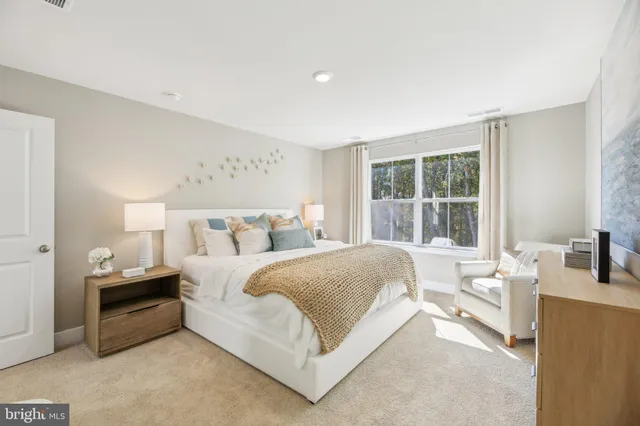 a spacious bedroom with a bed and a large window