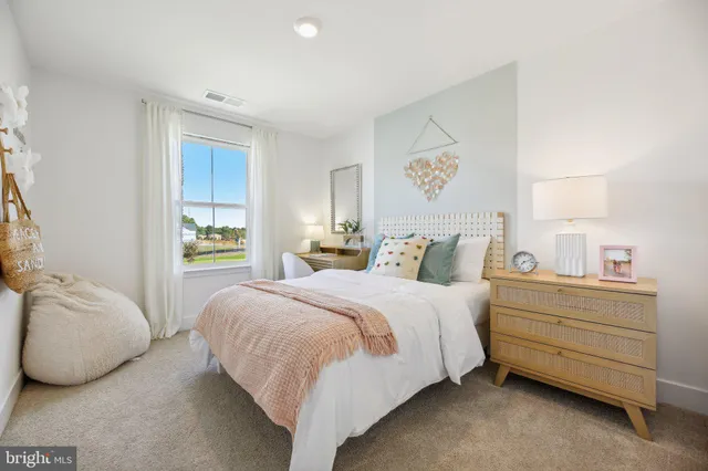 a bedroom with bed and window