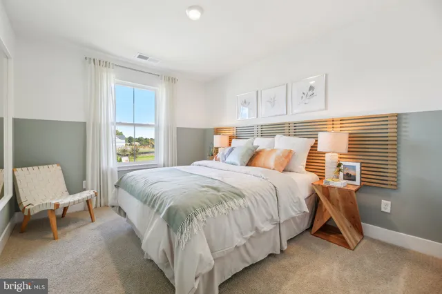 a bed room with a bed and a chair