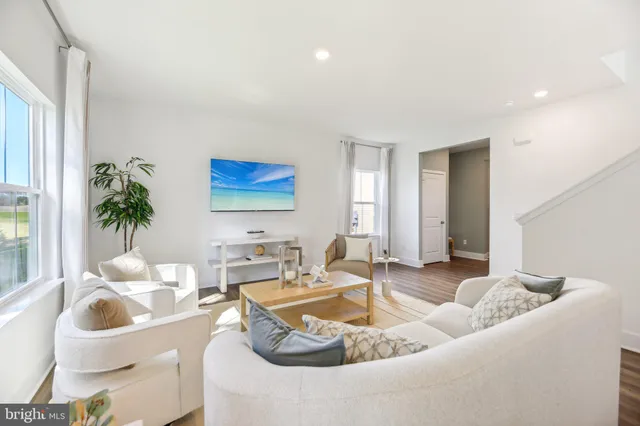 a living room with furniture and a large mirror