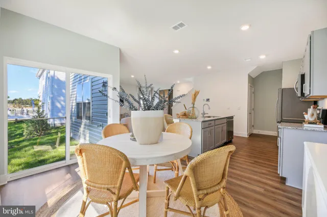 a dining room with furniture and a floor to ceiling window