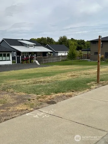 a aerial view of a house with a big yard and potted plants