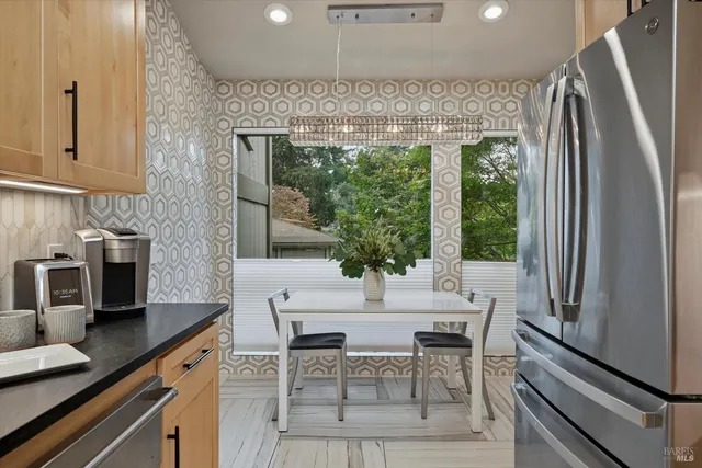 a dining room with furniture a floor to ceiling window and outdoor view