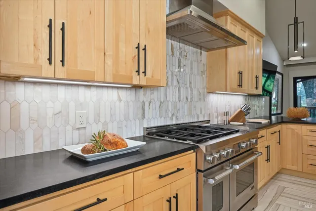a kitchen with stainless steel appliances white cabinets a stove and a sink
