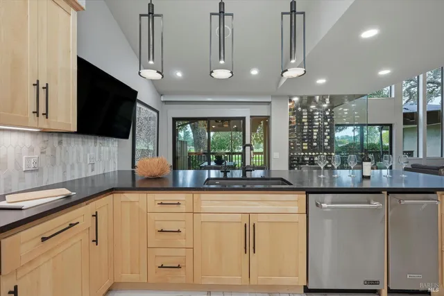 a kitchen with white cabinets and chandelier