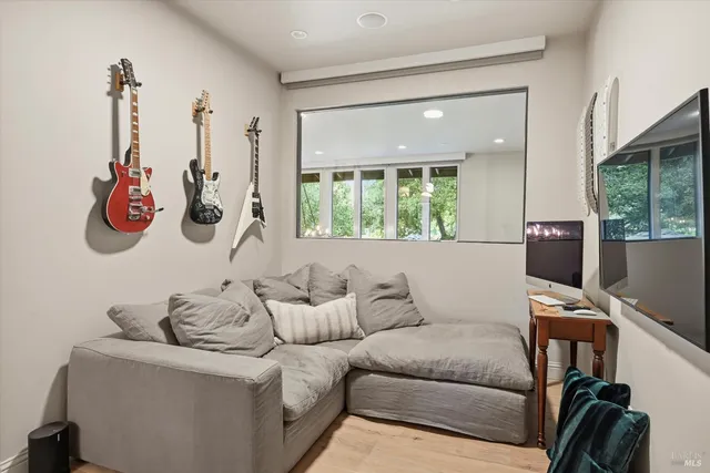 a bedroom with two beds and large window