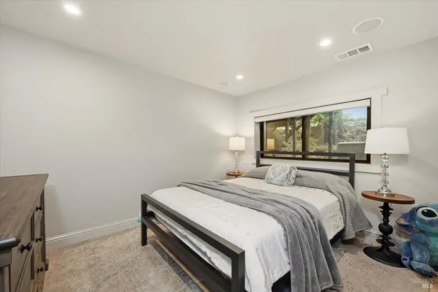 a bathroom with a granite countertop sink a mirror and shower