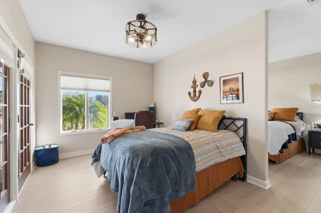 a bedroom with a bed a couch and a window