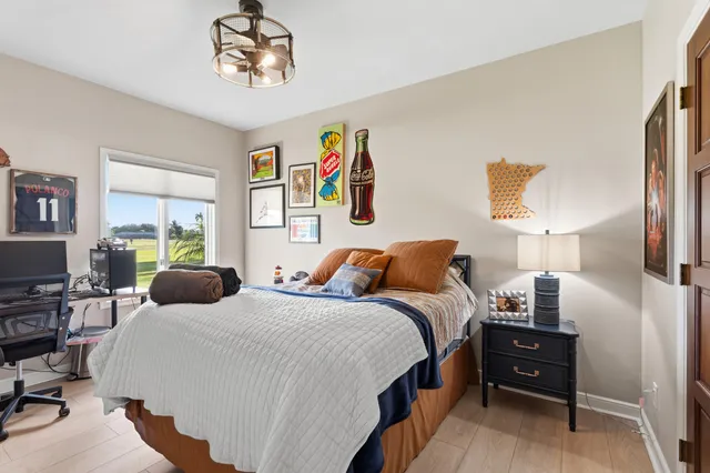 a bedroom with a bed and wooden floor