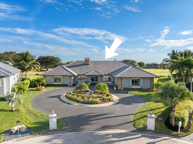 an aerial view of a house swimming pool and garden