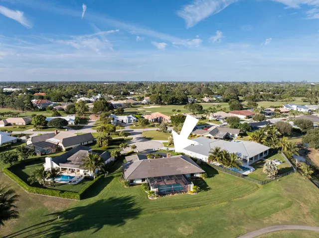 an aerial view of a city with lots of residential buildings and ocean view in back