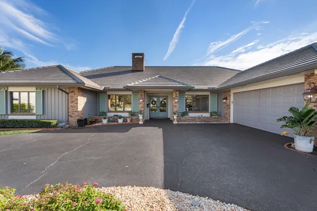a living room with furniture a fireplace and a chandelier