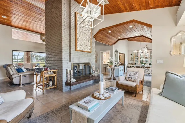 a dining room with furniture a rug and a large window