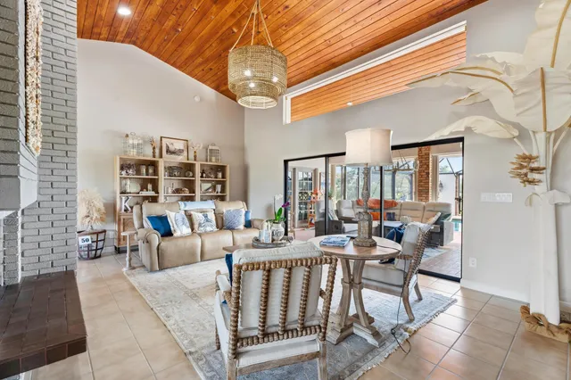a dining room with furniture a chandelier and fireplace