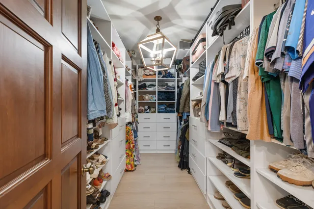 a bathroom with a sink a chair and a toilet