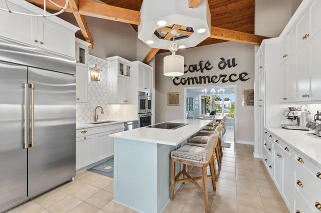 a kitchen with refrigerator and cabinets