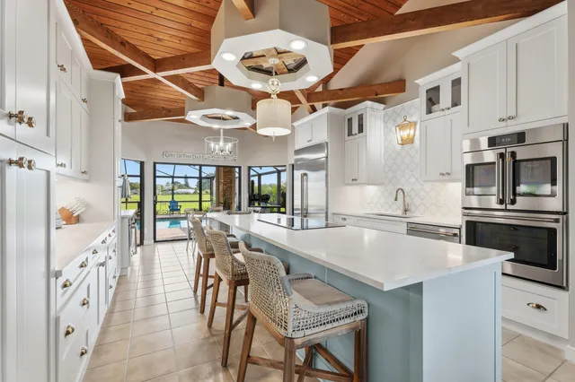 a large kitchen with a table and chairs