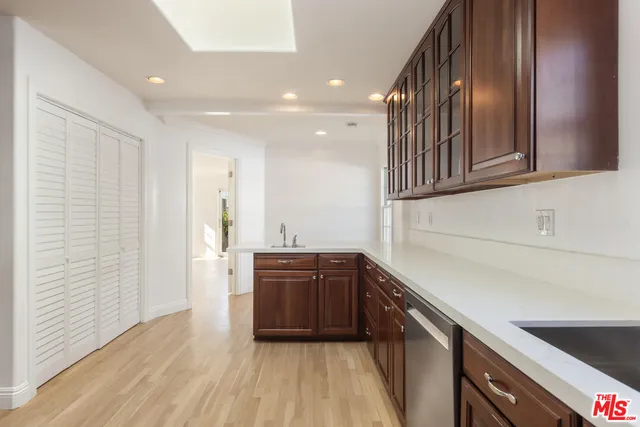 a kitchen with granite countertop a sink and cabinets