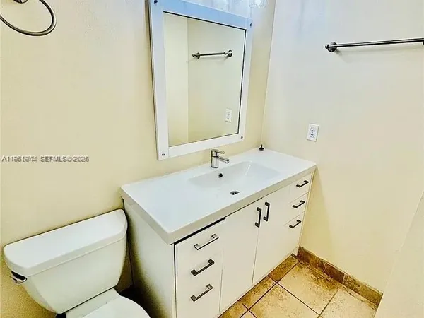 a bathroom with a sink toilet and mirror