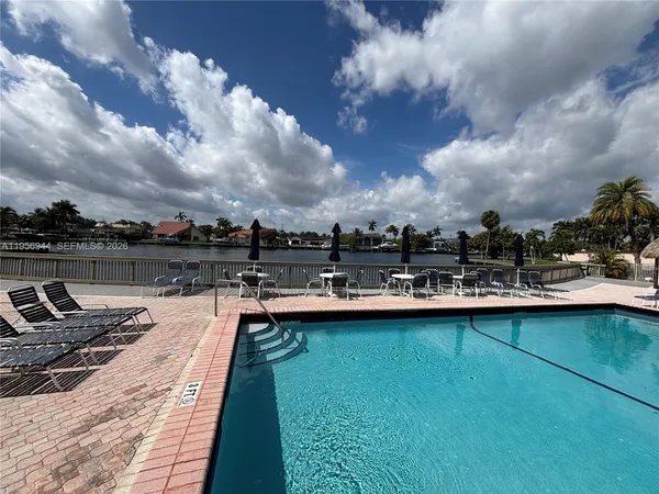a view of a swimming pool and a lounge chair