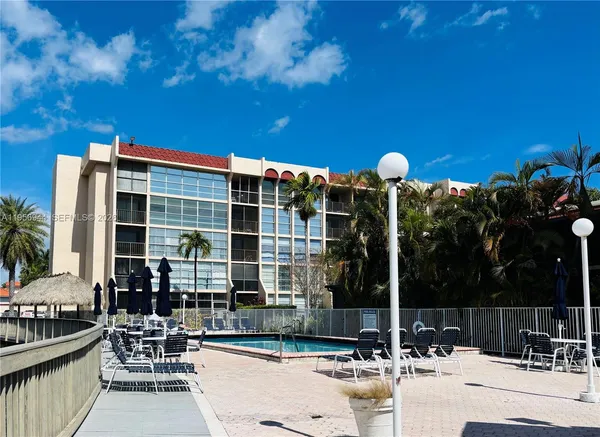 a view of a patio with a table and chairs and potted plants