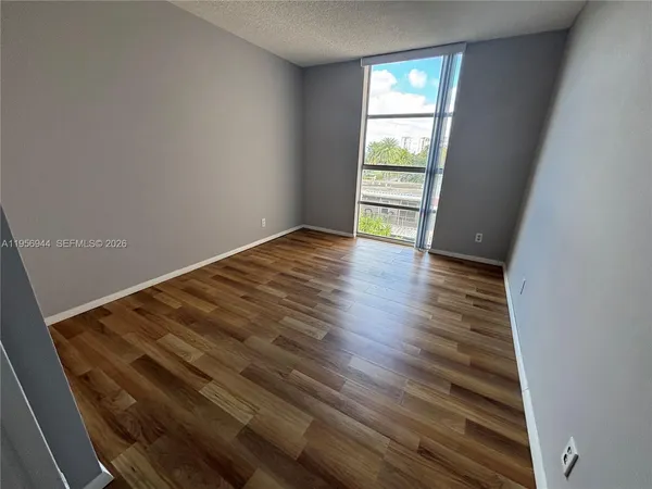 a view of wooden floor and windows in a room