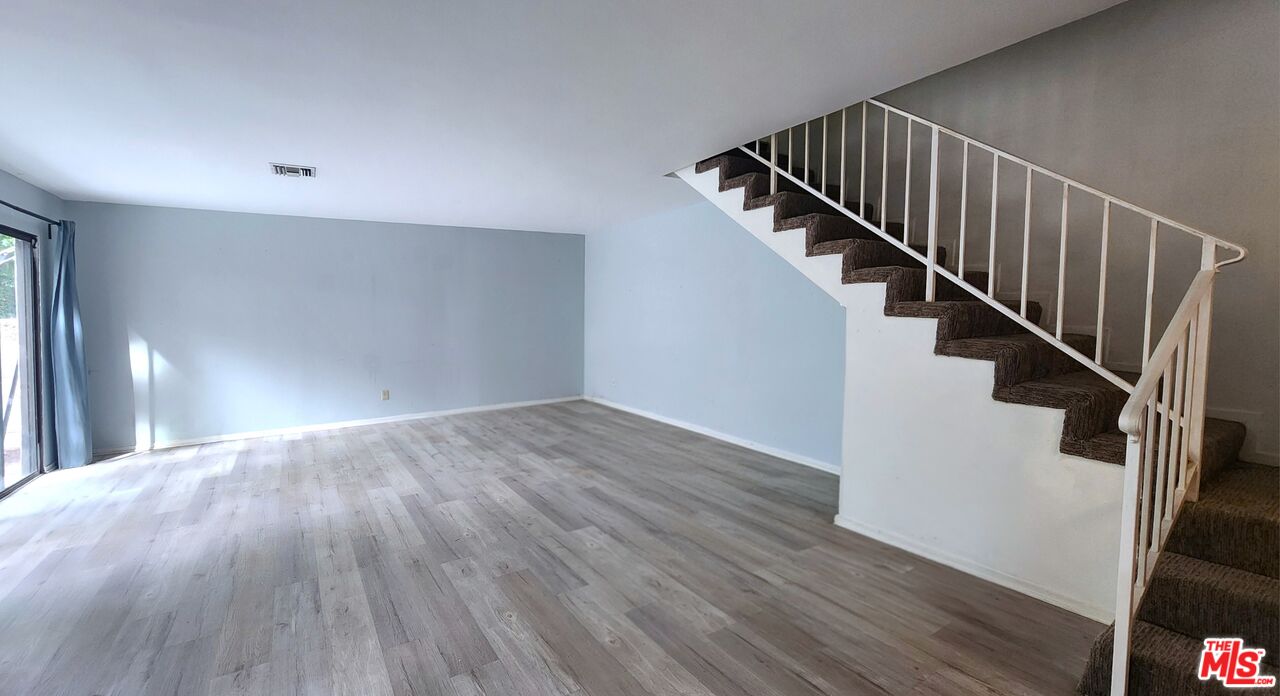 5227 Eagle Dale Avenue Los Angeles, CA 90041 - Photo 6 of 10 a view of staircase with wooden floor and white walls