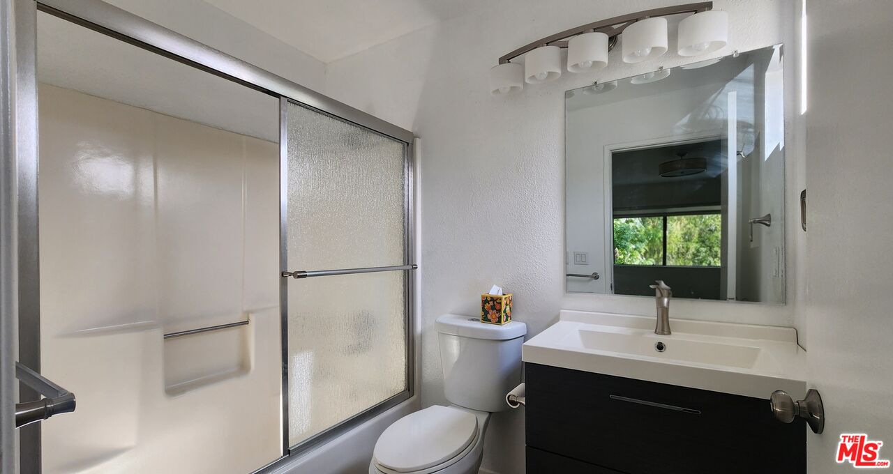 5227 Eagle Dale Avenue Los Angeles, CA 90041 - Photo 9 of 10 a bathroom with a sink toilet a mirror and shower
