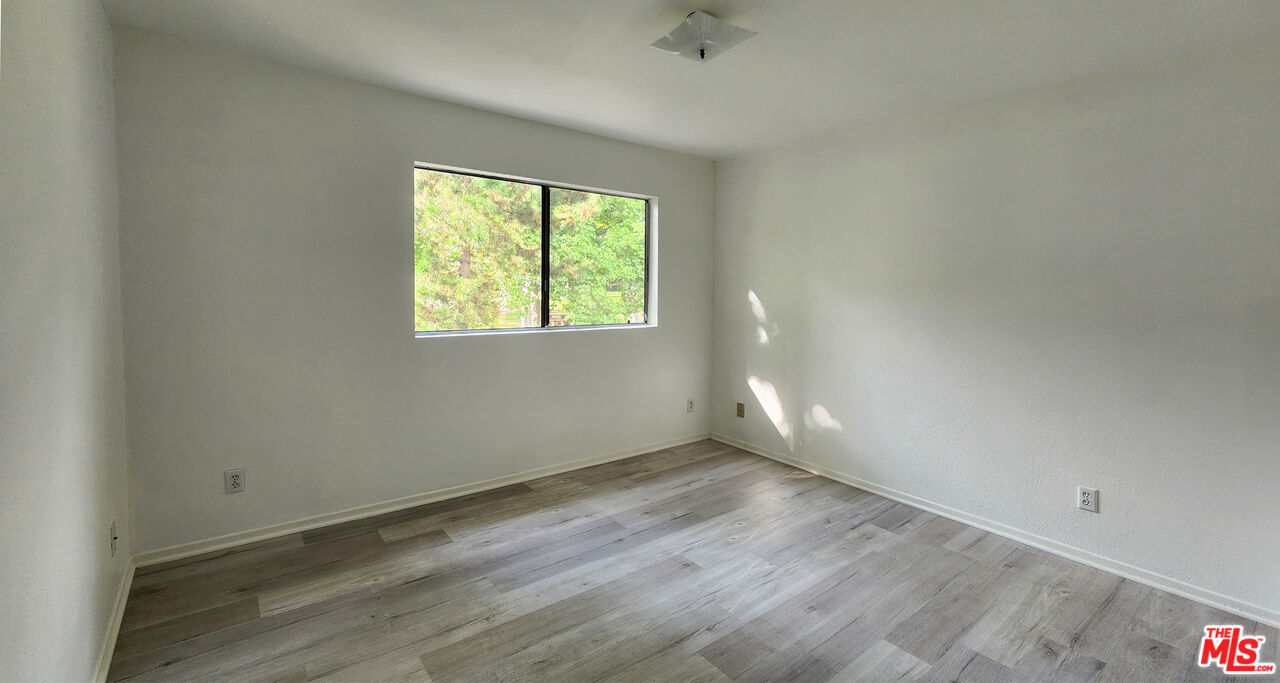 5227 Eagle Dale Avenue Los Angeles, CA 90041 - Photo 10 of 10 an empty room with wooden floor and windows