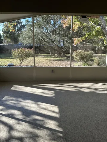a view of empty room with floor to ceiling window