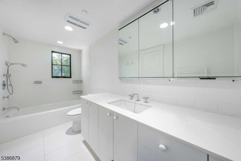 60 Fernwood Road Summit, NJ 07901 - Photo 33 of 50 a bathroom with a sink a toilet and bathtub