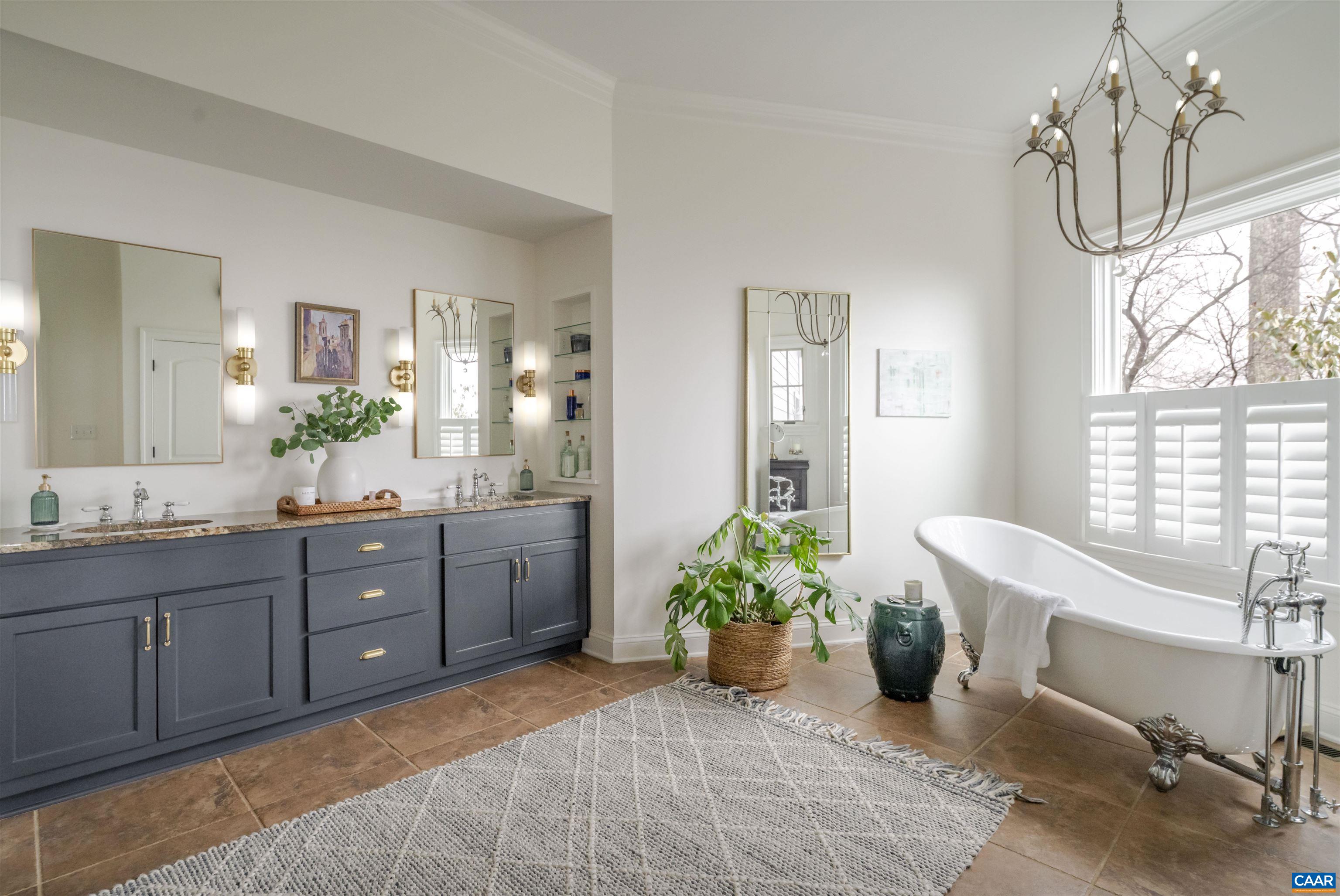 765 Summit Ridge Point Charlottesville, VA 22911 - Photo 18 of 60 a spacious bathroom with a tub sink and mirror