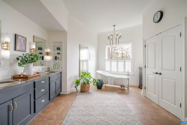 a kitchen with granite countertop white cabinets sink and window