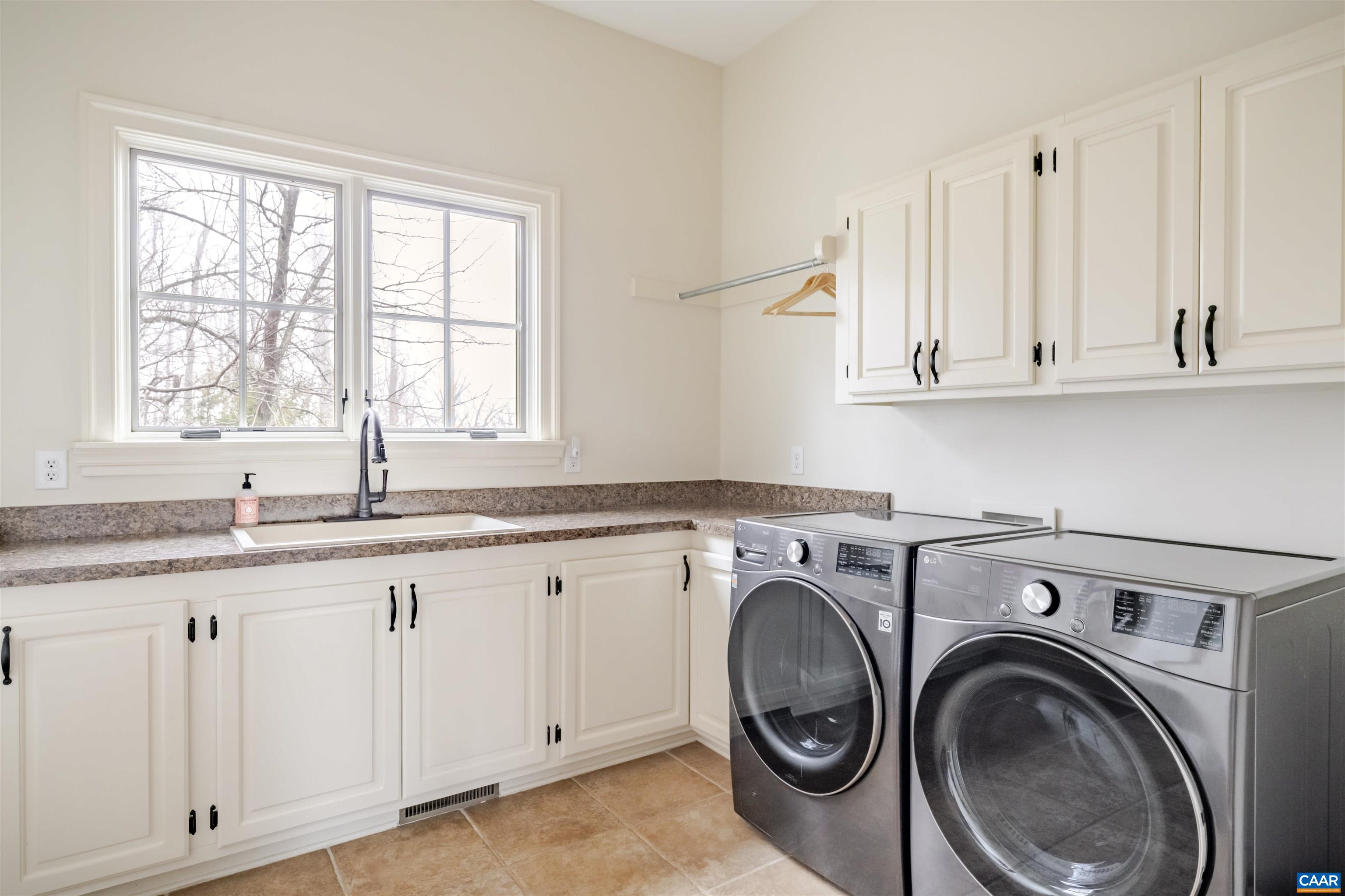 765 Summit Ridge Point Charlottesville, VA 22911 - Photo 23 of 60 a kitchen with granite countertop white cabinets sink and window