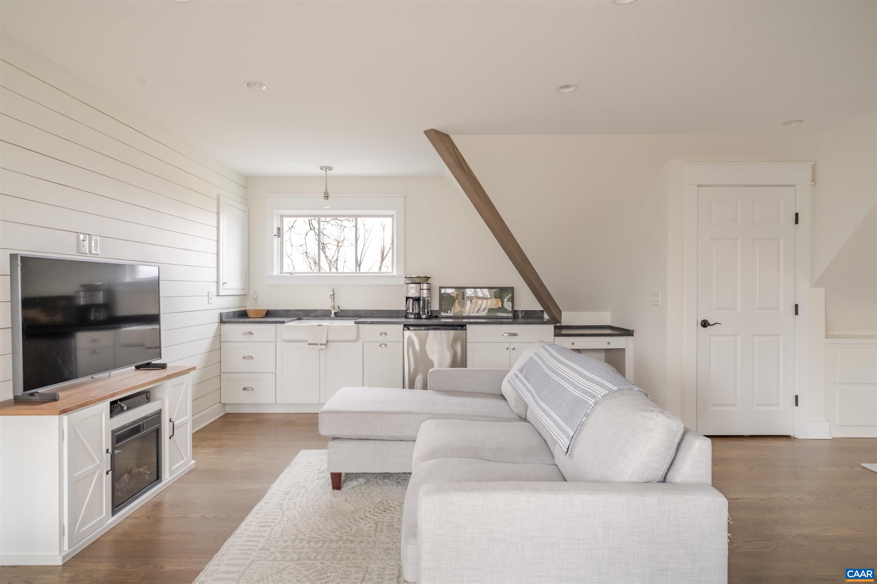 765 Summit Ridge Point Charlottesville, VA 22911 - Photo 25 of 60 a living room with furniture and a flat screen tv