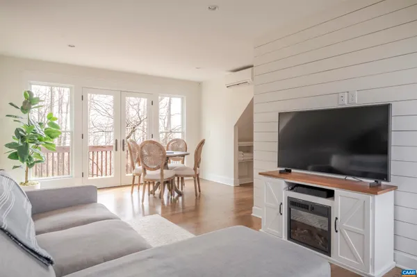 a spacious bedroom with a bed couch and a large window