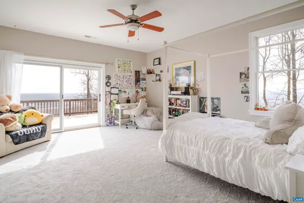 a bedroom with furniture and a large window