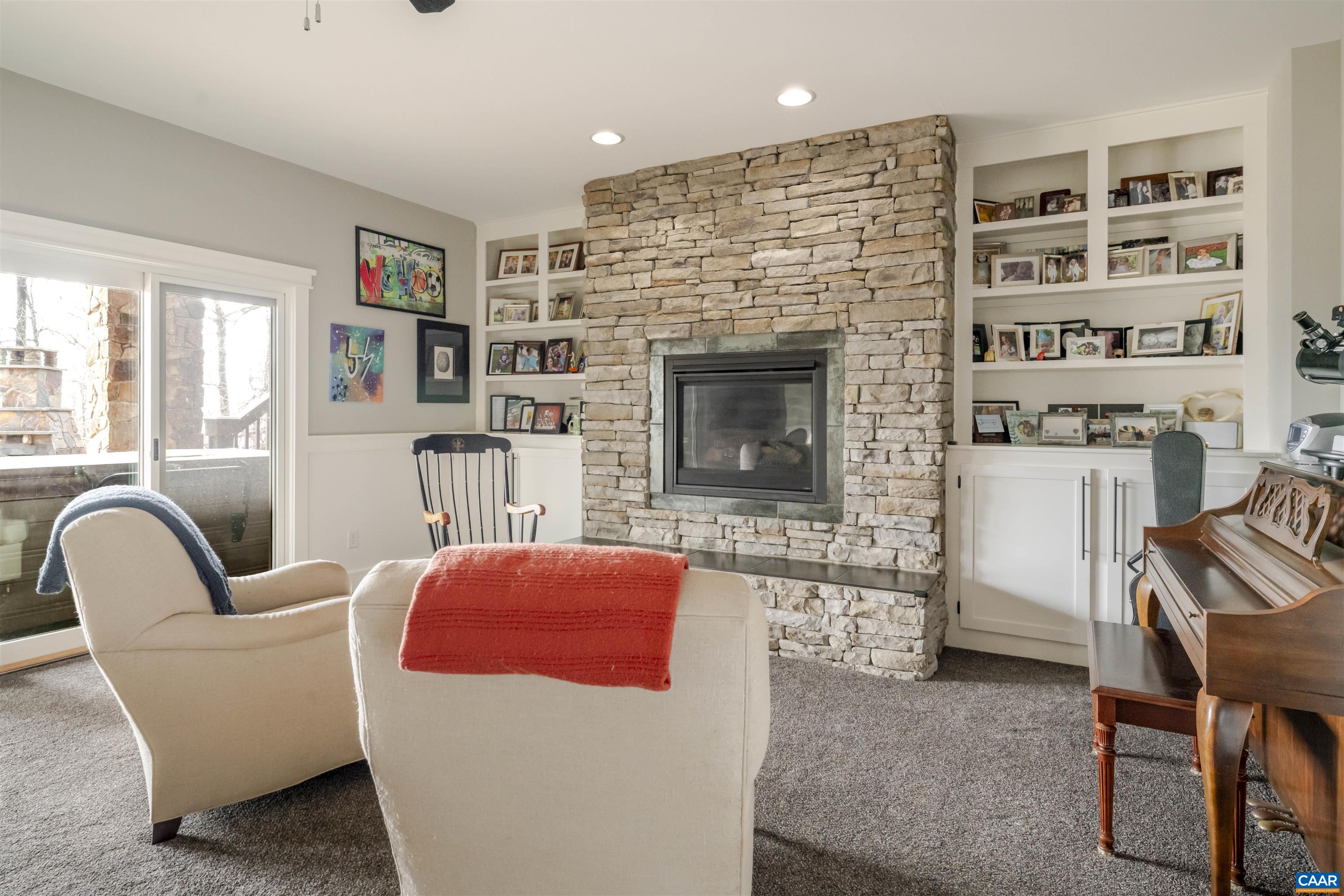 765 Summit Ridge Point Charlottesville, VA 22911 - Photo 45 of 60 a living room with furniture a flat screen tv and a fireplace