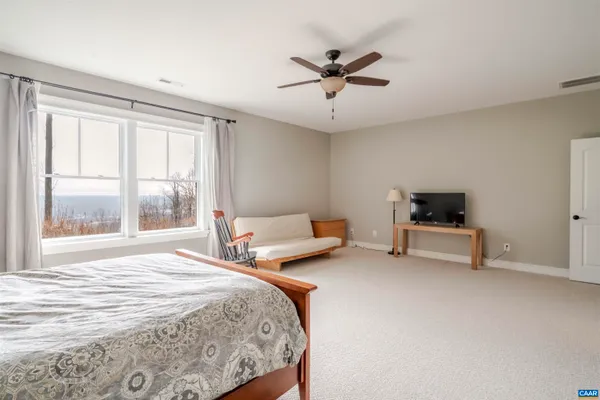 a front view of a house with a yard and outdoor seating