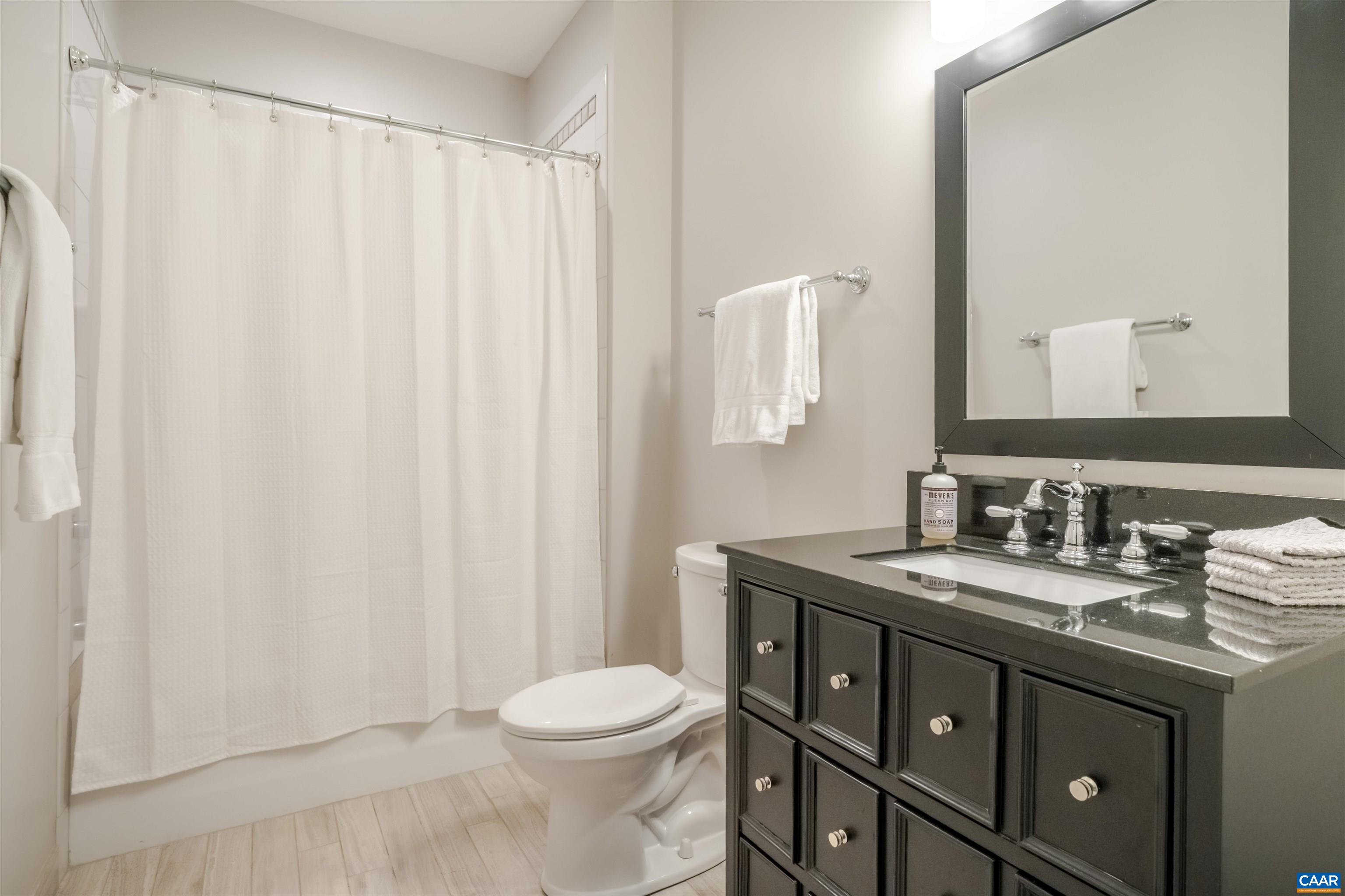 765 Summit Ridge Point Charlottesville, VA 22911 - Photo 48 of 60 a bathroom with a double vanity sink toilet and a mirror