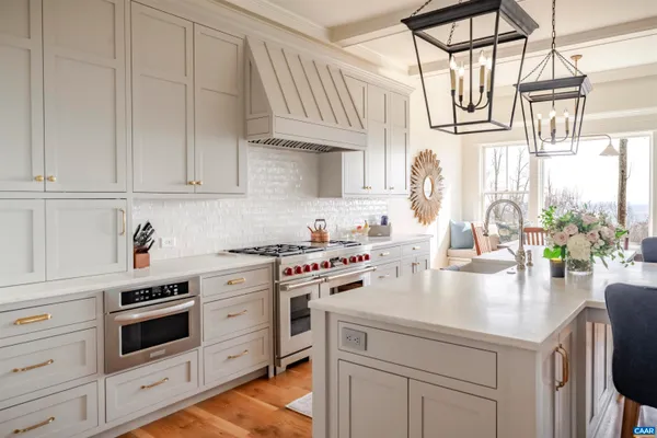 a kitchen with stainless steel appliances granite countertop a white cabinets and a refrigerator