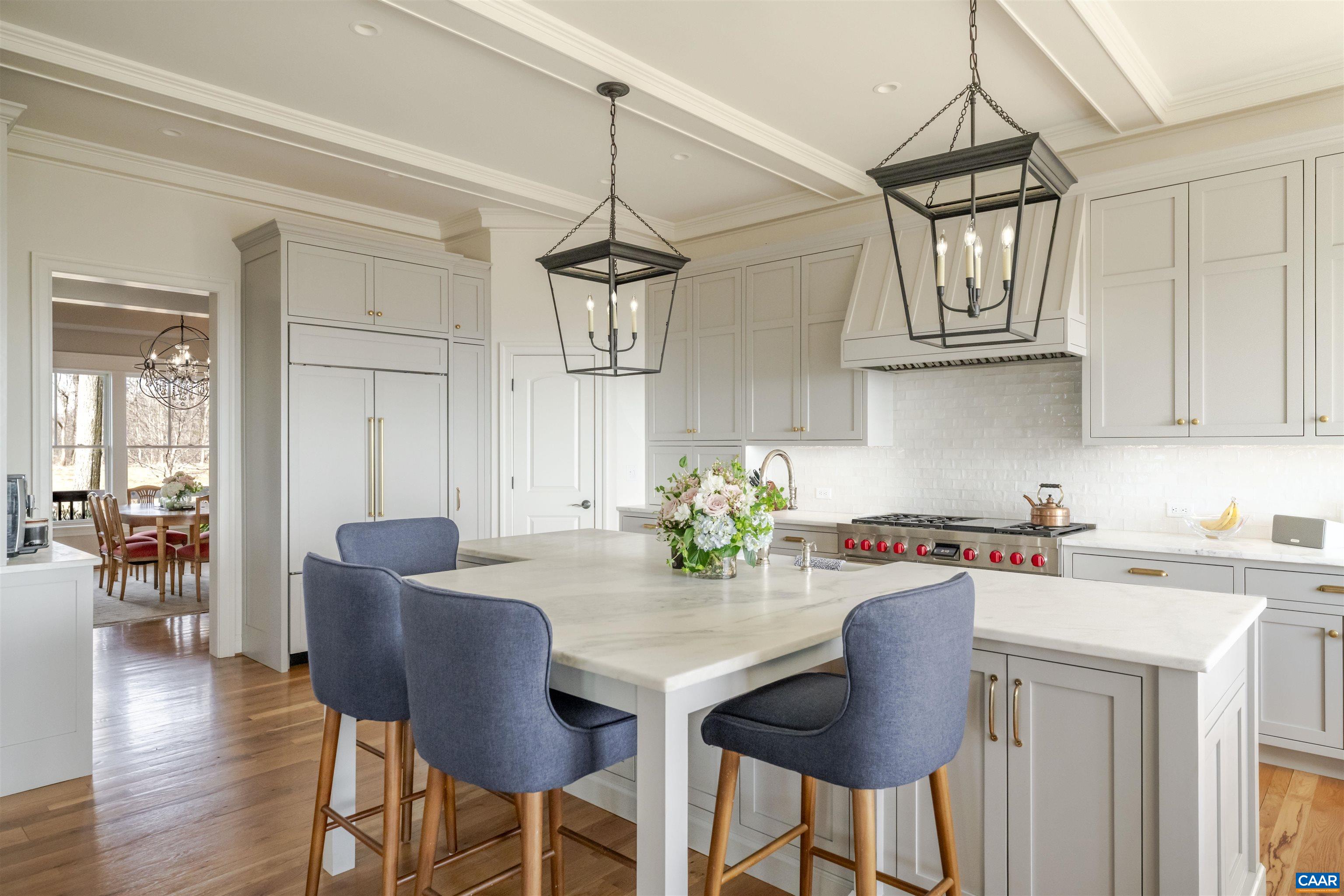 765 Summit Ridge Point Charlottesville, VA 22911 - Photo 8 of 60 a kitchen with stainless steel appliances granite countertop a kitchen island hardwood floor sink stove dining table and chairs